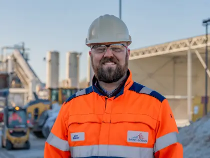 Man standing in front of glass site in PPE